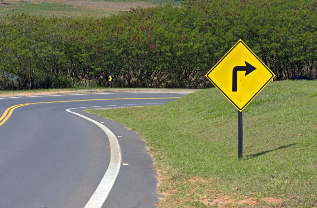 Signpost of sharp curve on road of Sao Paulo, Brazil